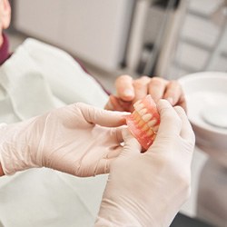 A man discussing dentures with his dentist