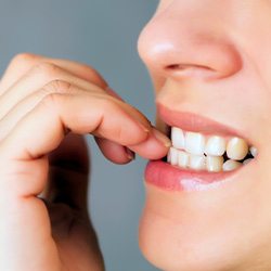 Closeup of woman biting her nails