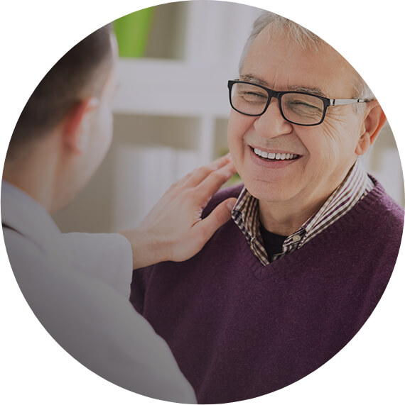 Smiling older man shaking dentist's hand