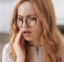 Woman in pain holding jaw