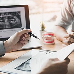 A dentist and patient discussing dental implants in Wylie