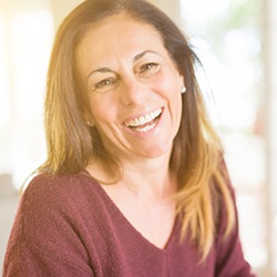 Woman smiling happily in red sweater outside