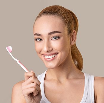 Woman holding a toothbrush