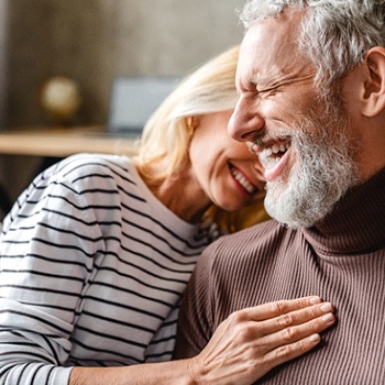 Senior couple enjoying the benefits of implant dentures