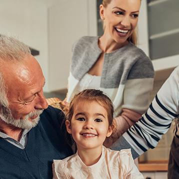 Three generations of family laughing together