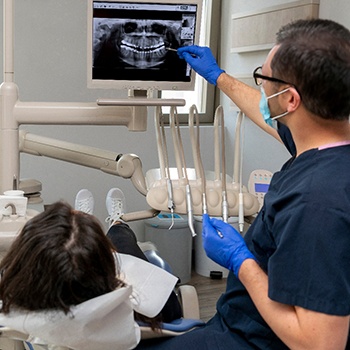a dentist showing a patient her X-ray