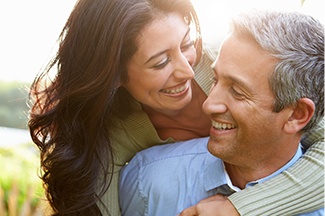 Smiling man and woman outdoors