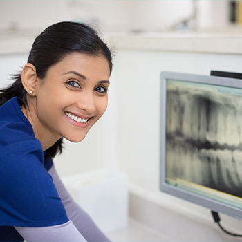 Dentist looking at digital x-rays