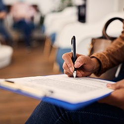 Patient in Wylie filling out paperwork for teeth whitening