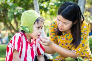 parent wiping blood from their child's mouth