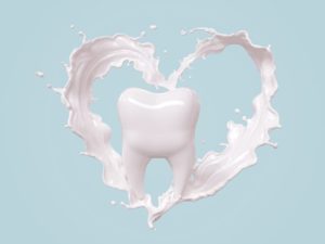 tooth with milk making the shape of a heart around it