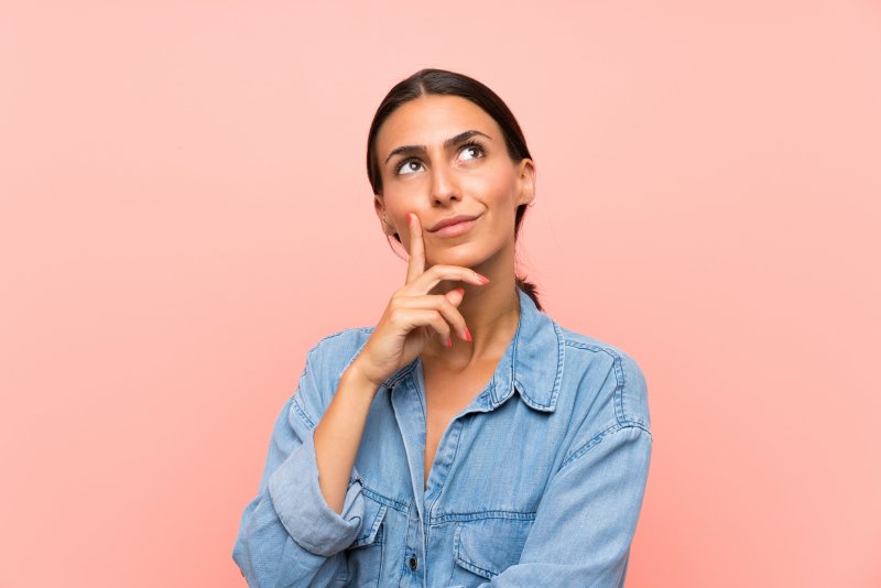 Woman in blue shirt thinking